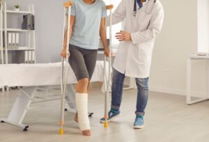 Woman on crutches with broken leg